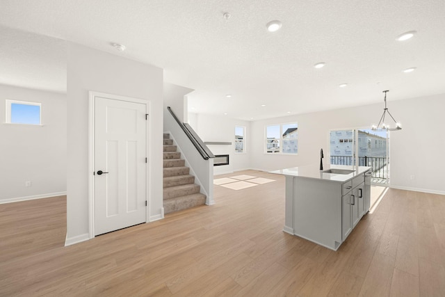 6738 Wildflower Way, Minnetrista, MN 55331 - kitchen featuring a sink, light wood-style flooring, open floor plan, healthy amount of natural light, and recessed lighting