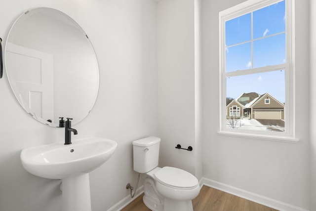 6738 Wildflower Way, Minnetrista, MN 55331 - half bathroom featuring baseboards, wood finished floors, toilet, and plenty of natural light