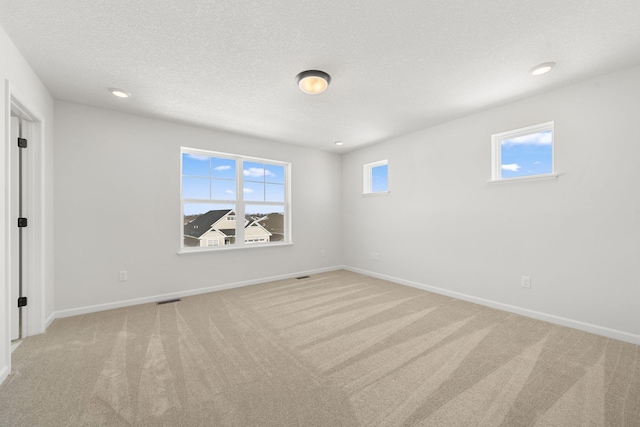 6738 Wildflower Way, Minnetrista, MN 55331 - unfurnished bedroom featuring light colored carpet, baseboards, a textured ceiling, and recessed lighting