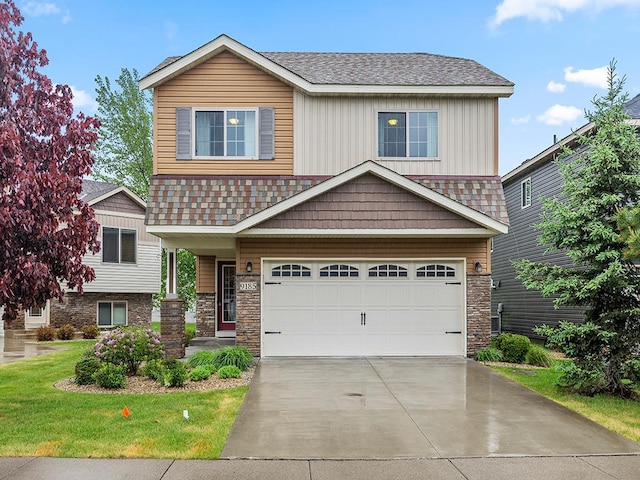 9185 Golden Pond Ln N, Monticello, MN 55362 - view of front of property featuring an attached garage, stone siding, concrete driveway, a shingled roof, and a front yard