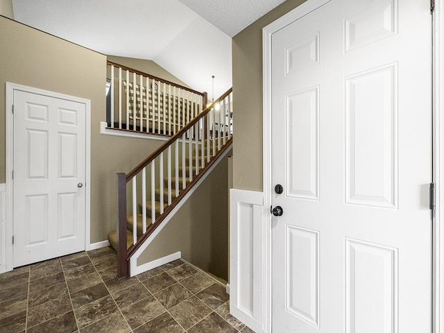 9185 Golden Pond Ln N, Monticello, MN 55362 - staircase with vaulted ceiling and baseboards