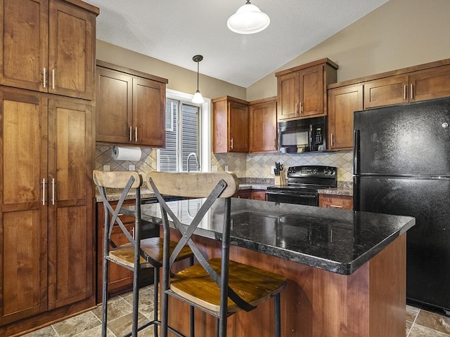 9185 Golden Pond Ln N, Monticello, MN 55362 - kitchen featuring black appliances, lofted ceiling, stone tile floors, backsplash, and a breakfast bar area