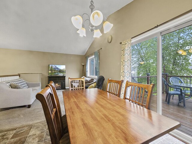 9185 Golden Pond Ln N, Monticello, MN 55362 - dining space featuring a chandelier, a lit fireplace, and vaulted ceiling