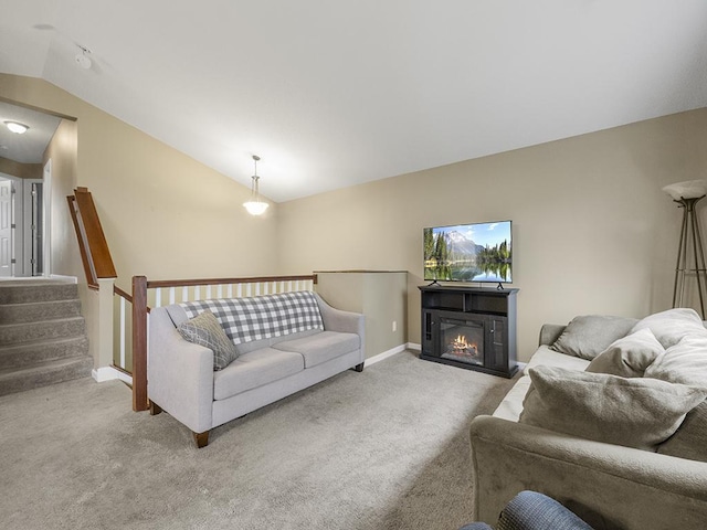 9185 Golden Pond Ln N, Monticello, MN 55362 - carpeted living room with vaulted ceiling, baseboards, and a warm lit fireplace