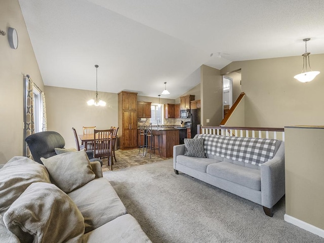 9185 Golden Pond Ln N, Monticello, MN 55362 - living room featuring light colored carpet, vaulted ceiling, a chandelier, and baseboards