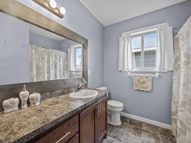 9185 Golden Pond Ln N, Monticello, MN 55362 - bathroom featuring plenty of natural light, vanity, toilet, and baseboards
