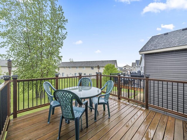 9185 Golden Pond Ln N, Monticello, MN 55362 - wooden terrace with outdoor dining space and a residential view