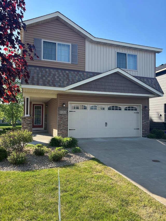 9185 Golden Pond Ln N, Monticello, MN 55362 - view of front of property with driveway, a front lawn, board and batten siding, and an attached garage