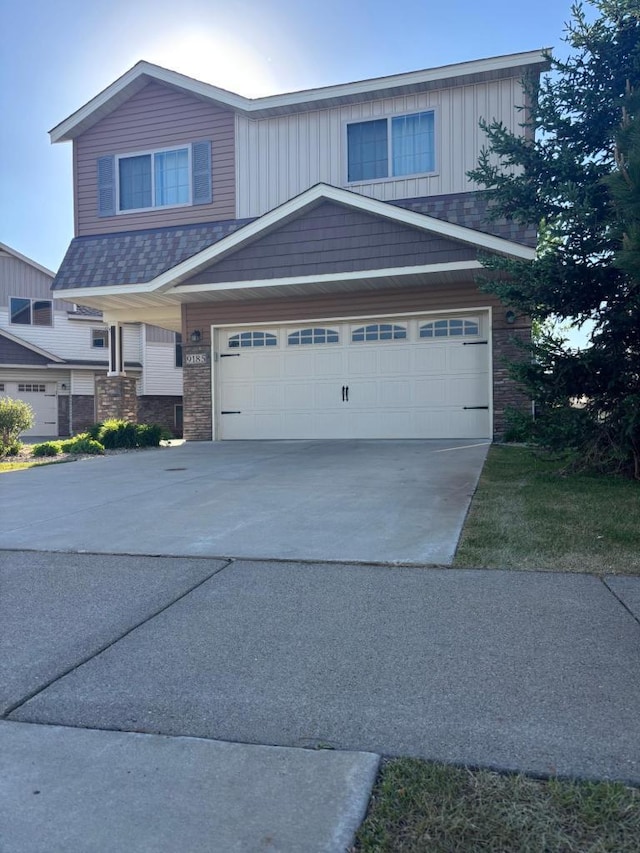9185 Golden Pond Ln N, Monticello, MN 55362 - view of front of home with driveway, an attached garage, and board and batten siding