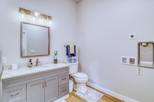49581 Trowbridge Cir, Candor Twp, MN 56587 - half bath with toilet, baseboards, wood finished floors, and vanity
