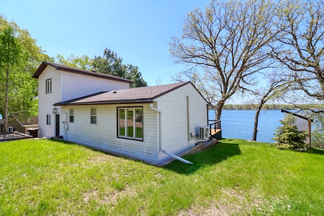 49581 Trowbridge Cir, Candor Twp, MN 56587 - rear view of house with a yard, a water view, roof with shingles, and ac unit