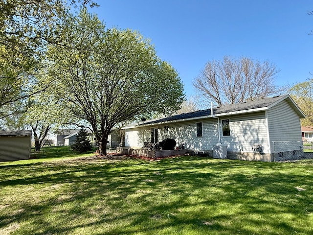 back of property featuring crawl space and a lawn