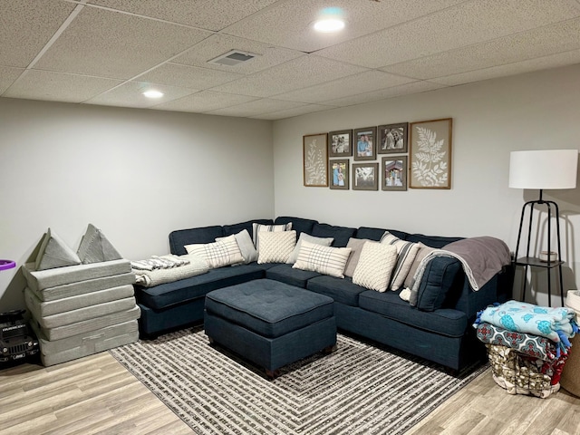 living area featuring recessed lighting, visible vents, and wood finished floors
