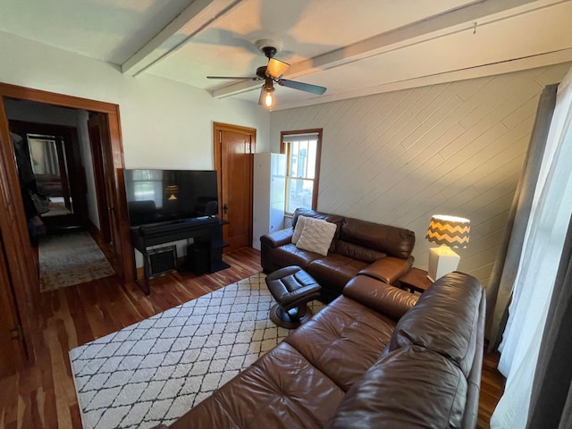 living room with beamed ceiling, ceiling fan, and wood finished floors