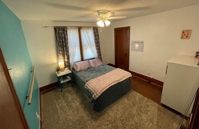 bedroom featuring baseboards and ceiling fan