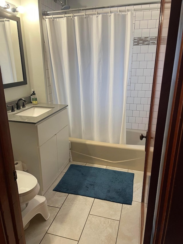 bathroom featuring tile patterned flooring, shower / tub combo with curtain, toilet, and vanity