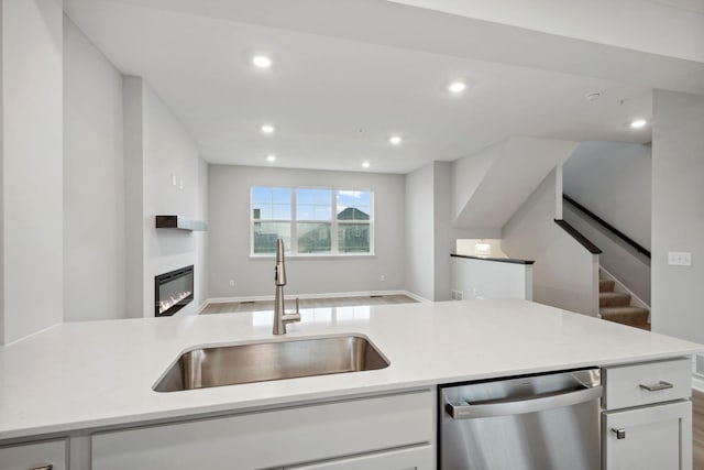 6754 Wildflower Way, Minnetrista, MN 55331 - kitchen featuring dishwasher, a sink, white cabinets, open floor plan, and recessed lighting