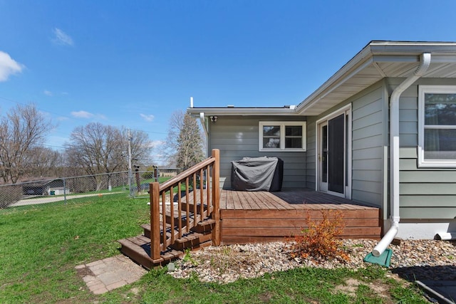 wooden deck with a yard and fence