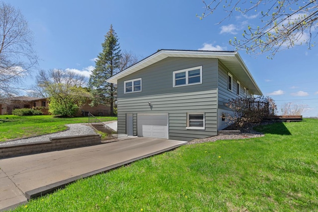 view of side of property with concrete driveway, a garage, and a lawn
