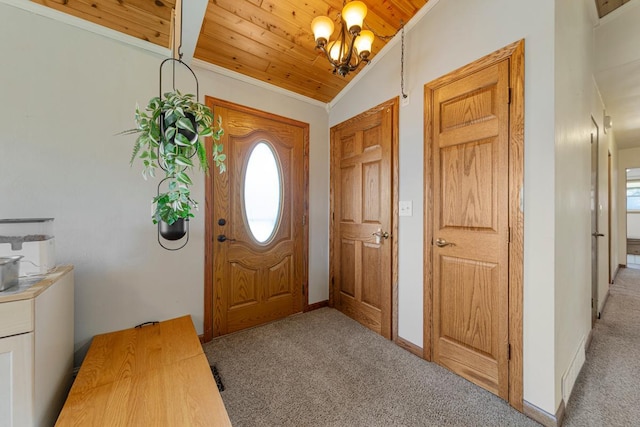 entrance foyer featuring ornamental molding, a notable chandelier, light colored carpet, and wooden ceiling