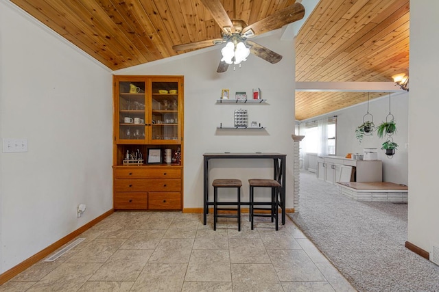 dining room with lofted ceiling, baseboards, wooden ceiling, and a ceiling fan