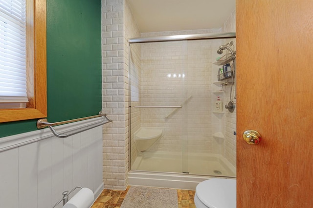 full bathroom featuring toilet and a shower stall