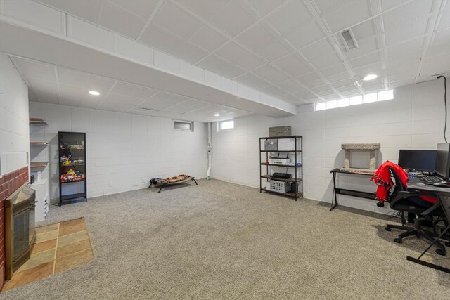 home office featuring carpet, concrete block wall, and recessed lighting