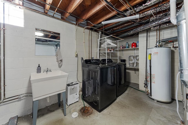 unfinished basement with washing machine and dryer, gas water heater, and concrete block wall