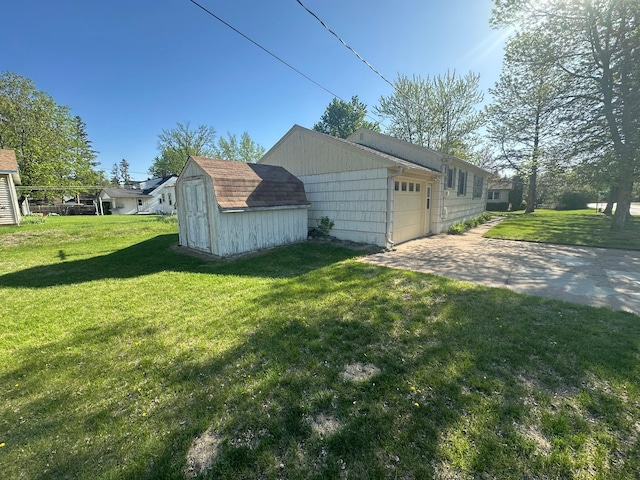 view of side of property with a storage shed, a lawn, a garage, and driveway