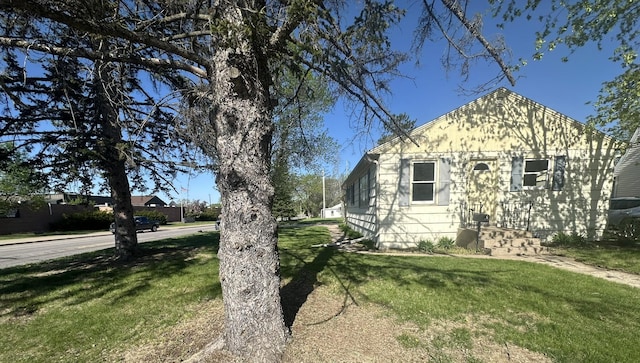 view of side of home featuring a yard