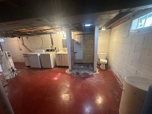 below grade area featuring washer and dryer and water heater