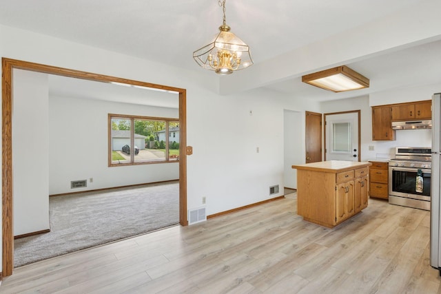 3697 75th St E, Inver Grove Heights, MN 55076 - kitchen featuring stainless steel gas stove, under cabinet range hood, a chandelier, and light wood finished floors