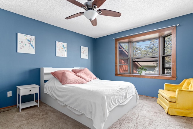 bedroom featuring carpet, a textured ceiling, a ceiling fan, and baseboards