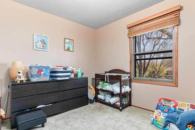 carpeted bedroom with a textured ceiling and baseboards