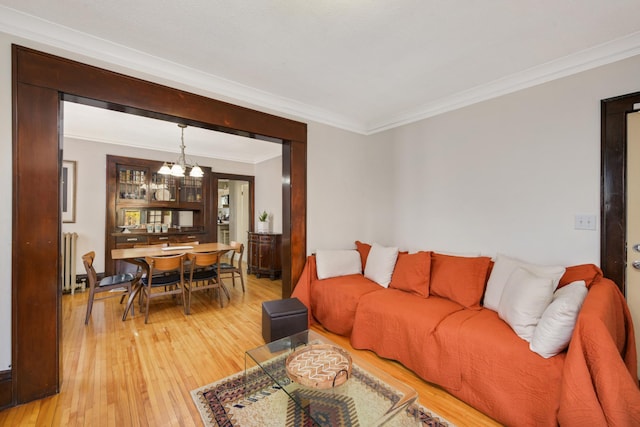 1828 Clinton Ave Unit 3, Minneapolis, MN 55404 - living area featuring a chandelier, light wood finished floors, ornamental molding, and radiator