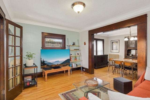 1828 Clinton Ave Unit 3, Minneapolis, MN 55404 - living area with radiator heating unit, ornamental molding, a chandelier, wood finished floors, and baseboards