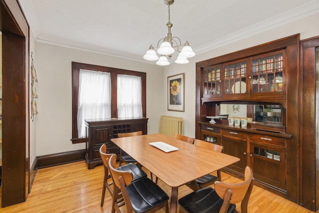 1828 Clinton Ave Unit 3, Minneapolis, MN 55404 - dining space featuring radiator heating unit, a chandelier, ornamental molding, light wood-type flooring, and baseboards