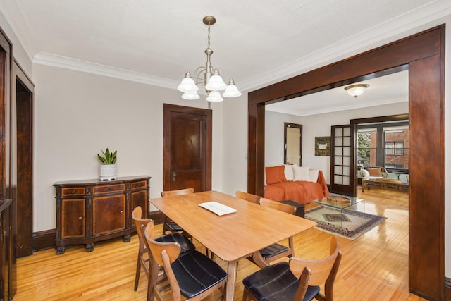 1828 Clinton Ave Unit 3, Minneapolis, MN 55404 - dining space featuring a chandelier, light wood-type flooring, and crown molding
