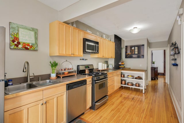 1828 Clinton Ave Unit 3, Minneapolis, MN 55404 - kitchen with stainless steel appliances, light brown cabinetry, a sink, and light wood-style floors