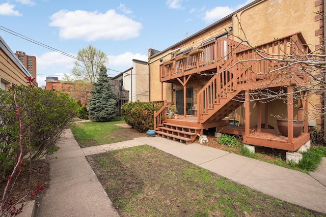 1828 Clinton Ave Unit 3, Minneapolis, MN 55404 - rear view of house with a wooden deck, a patio, and stucco siding