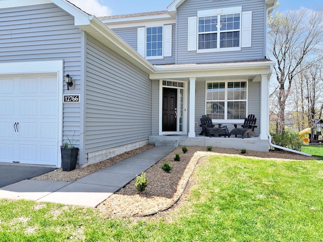 doorway to property with covered porch and a lawn