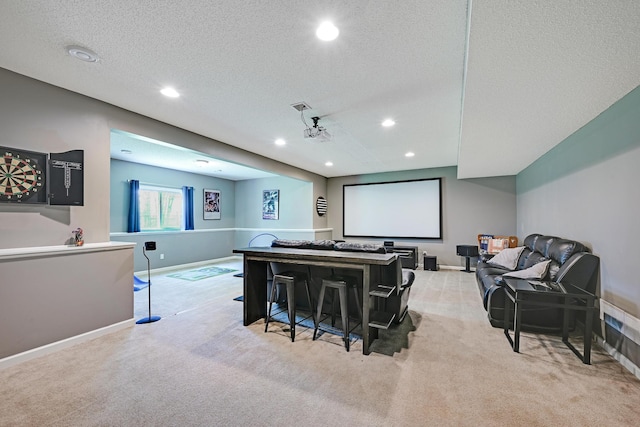 home theater featuring carpet flooring, recessed lighting, a textured ceiling, and baseboards