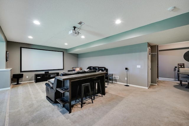 cinema room featuring carpet floors, recessed lighting, baseboards, and a textured ceiling