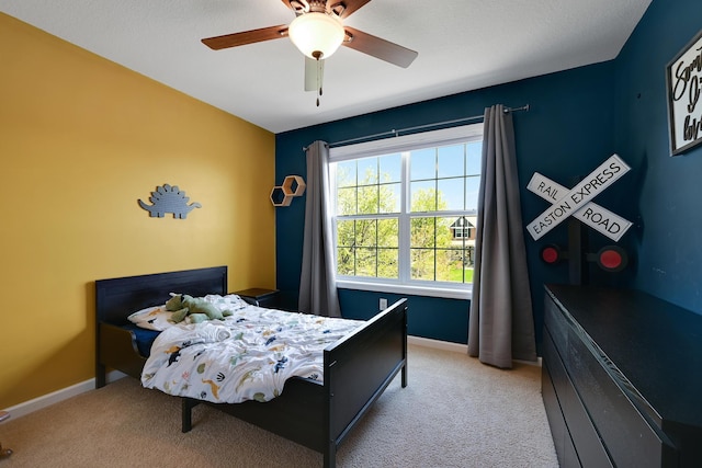 bedroom with light carpet, baseboards, and ceiling fan