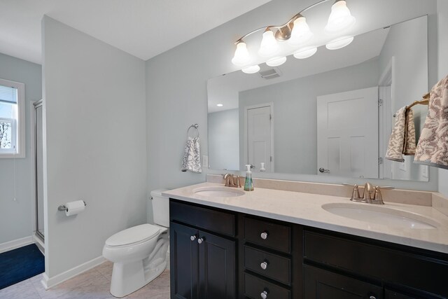 full bathroom with toilet, double vanity, a shower stall, and tile patterned flooring