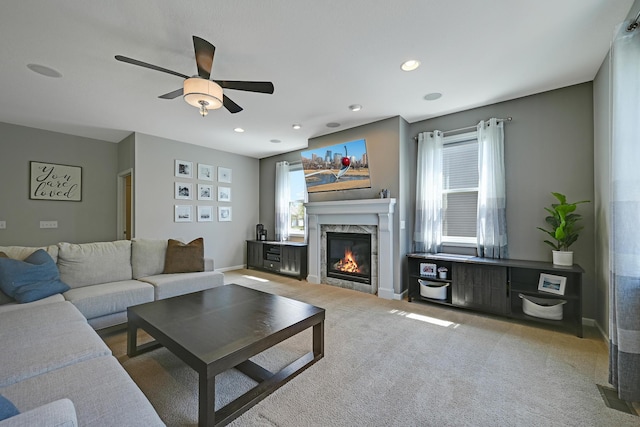 living room featuring a ceiling fan, a tile fireplace, carpet flooring, recessed lighting, and baseboards