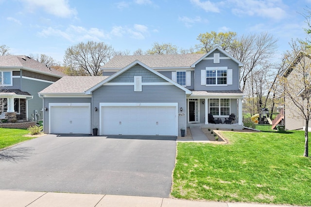 12766 Legacy Creek Pkwy NE, Blaine, MN 55449 - traditional-style home featuring driveway, roof with shingles, an attached garage, a front lawn, and covered porch