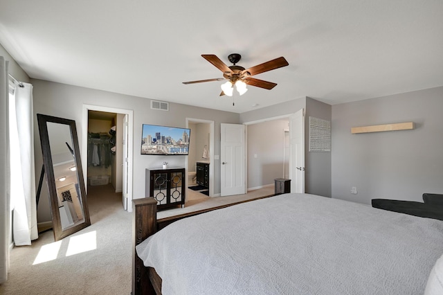 12766 Legacy Creek Pkwy NE, Blaine, MN 55449 - bedroom with a spacious closet, light carpet, a closet, a ceiling fan, and connected bathroom