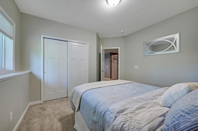 12766 Legacy Creek Pkwy NE, Blaine, MN 55449 - carpeted bedroom with a closet, baseboards, and a textured ceiling