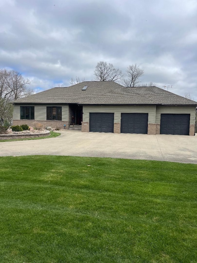 ranch-style home with driveway, brick siding, an attached garage, a shingled roof, and a front yard